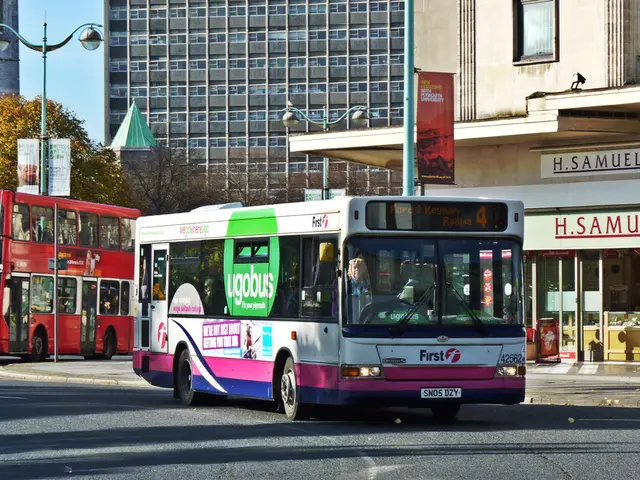 In the image we can see there are two buses standing on the road. On the other side of the buses...