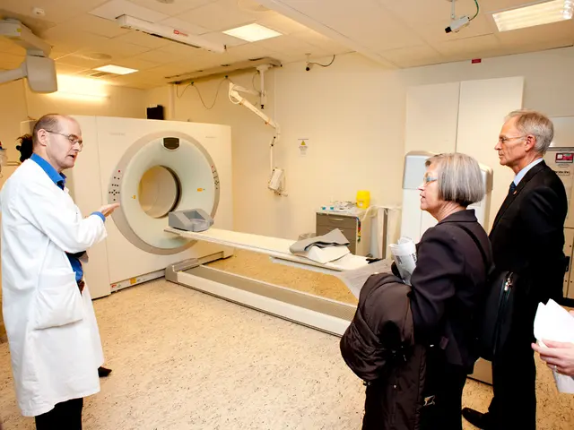 In this picture we can see the doctor in white uniform explaining about the CT scan machine to 2...