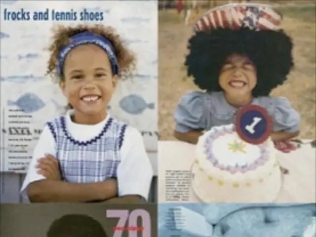 In the picture we can see three boys standing near the desk on it, we can see two computer systems...
