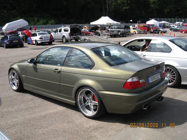 Completely an outdoor picture. There are number of vehicles in a parking area. Far there is a white...