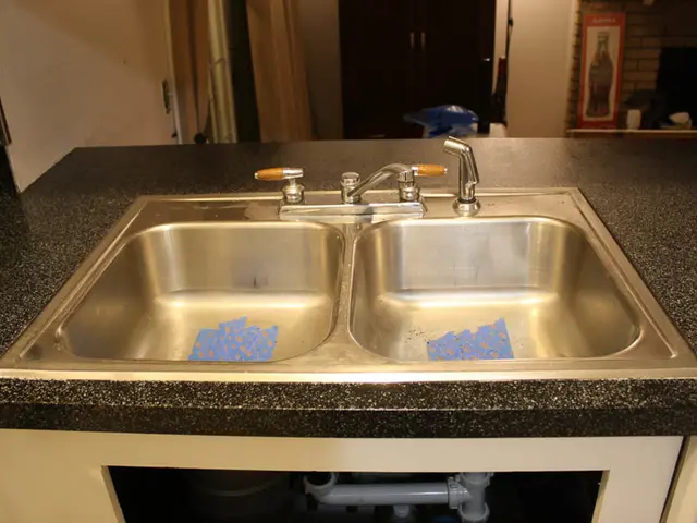 In this picture we can observe two sinks. There are tapes. We can observe a door. There is a...