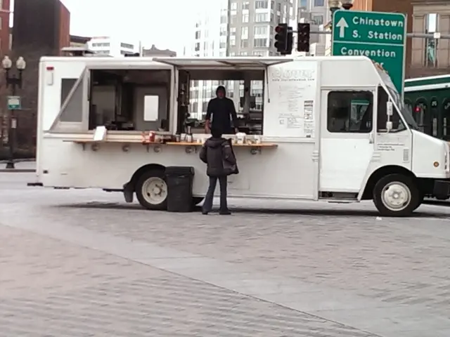 In this image in the middle there is a bus on that there is a man and some items, in front of that...