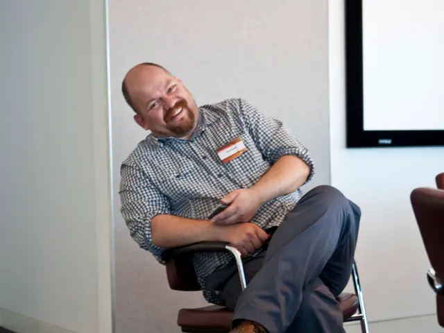 In this image the person is sitting on the chair.