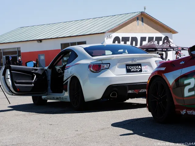 In this picture there is a white car on the road. On the right I can see the red car. In the back I...