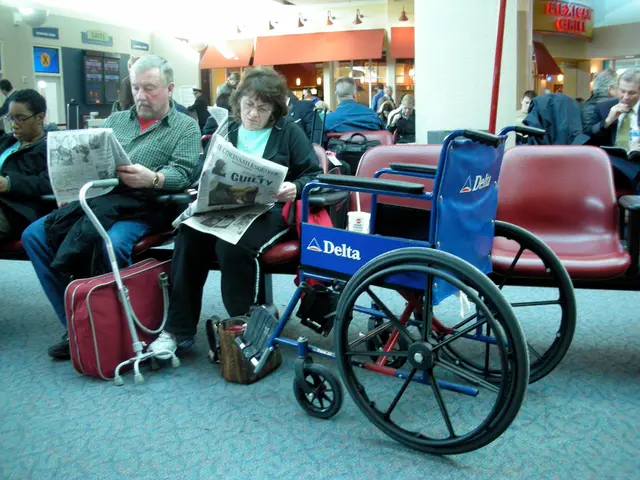 in this image there are few people visible on the chairs, in the foreground there is a wheelchair,...