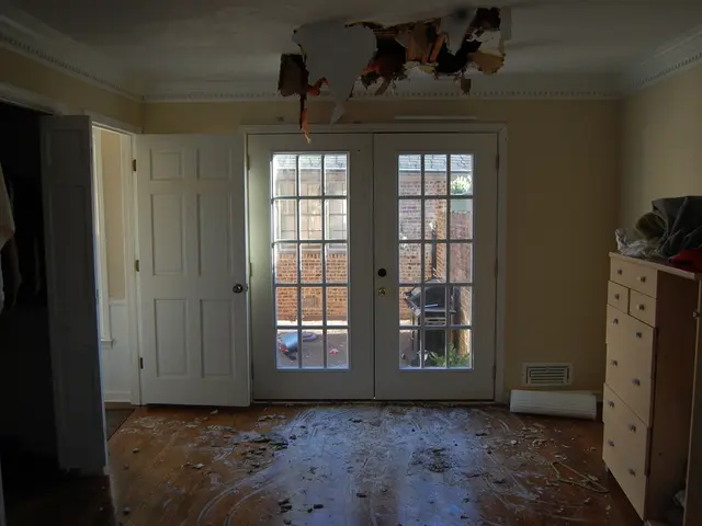 In this picture we can see a few blankets on a wooden desk on the right side. There is a white...