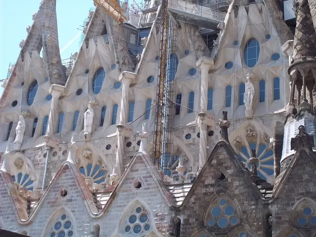 In this image I can see a building, it has few sculptures and construction is going on. There is...