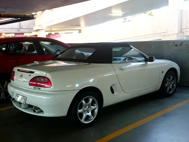 In the image we can see that there are cars parked in the cellar. At the top there is a pipe...