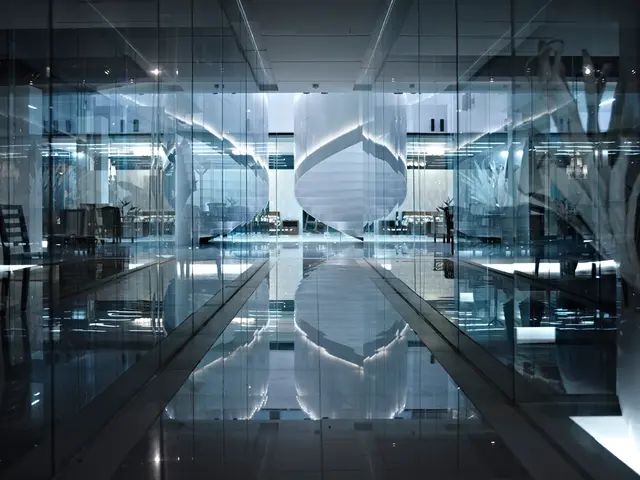 This is the inside picture of the building. In this image there are chairs, lights, glass doors. At...