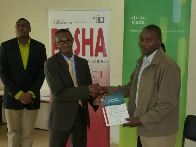 In this image there are persons holding a voucher. And at the back there are banners, beside that...