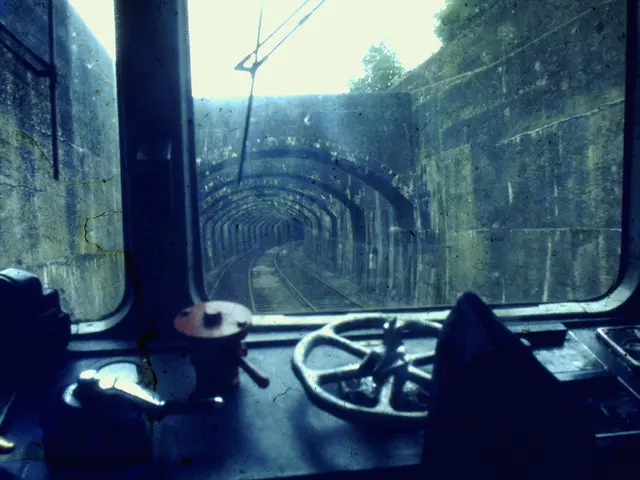 In this image I can see there is an interior view of the train and there are two railway tracks and...
