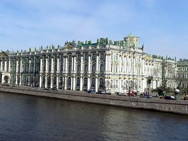 In this image I can see water, number of buildings, number of trees, number of vehicles, clouds,...