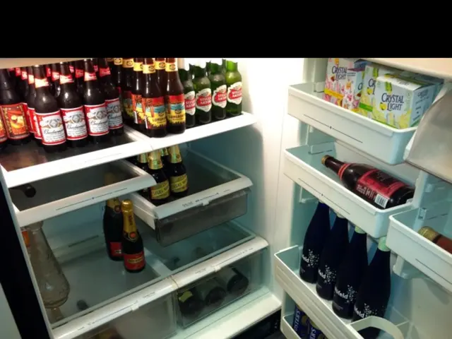 In this image I can see few bottles and few cardboard boxes in the refrigerator.
