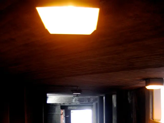 In the image I can see a place to which there is a door and some lamps to the roof.