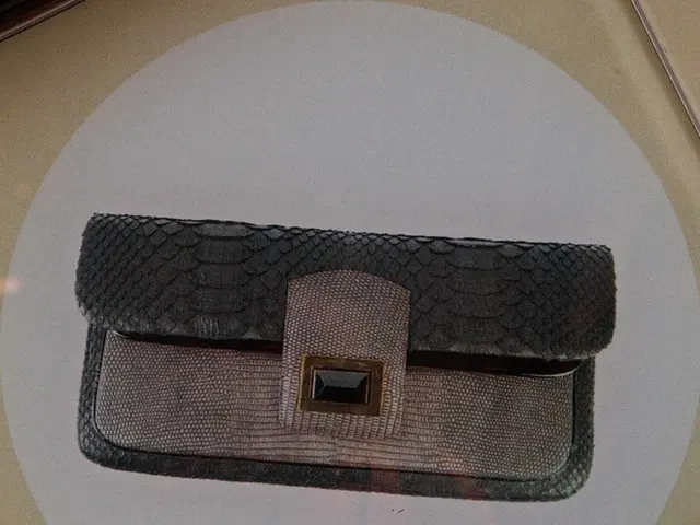 In the center of the image we can see the women wallet on the surface.