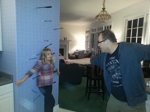 In the image we can see there are people who are standing and a man is holding a knife in his hand.