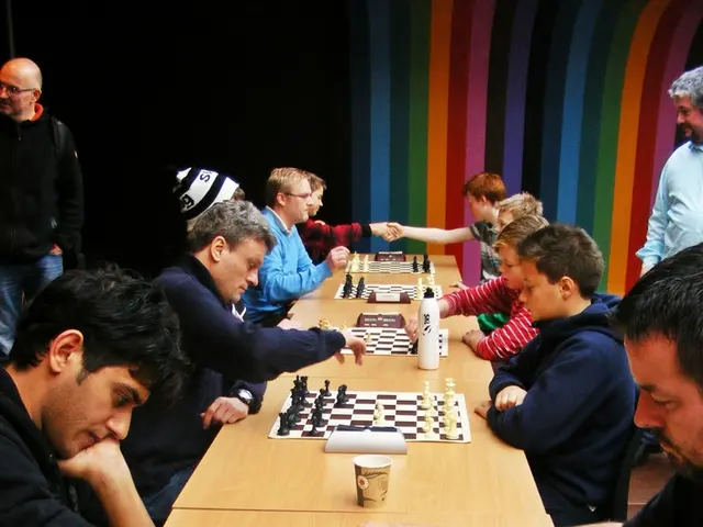 In this picture there are individuals sitting on their opposites playing chess and their is a clock...
