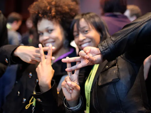 In the picture there are two women posing for the photo, they are wearing black jackets and the...