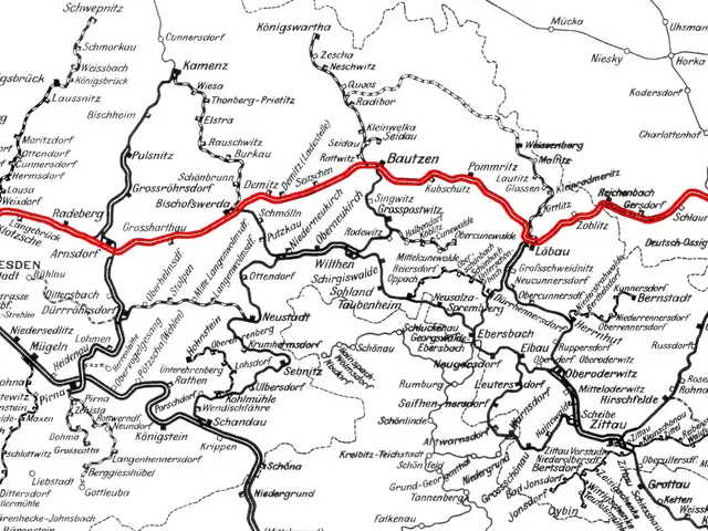 The image shows a black and white map of Germany with a red line running through it, indicating the...