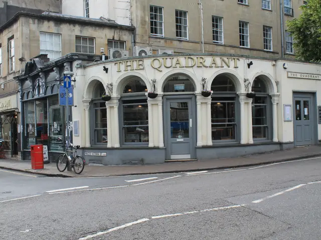 The image shows a quadrant pub in Bath, Somerset, England. There are buildings with windows and...