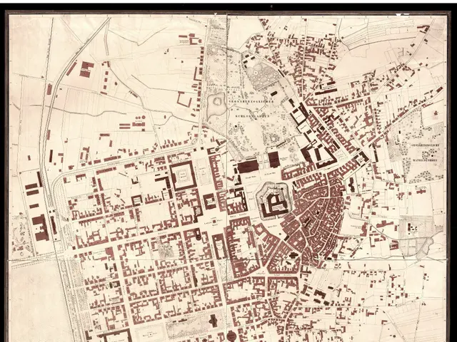 The image shows an old map of the city of Darmstadt, Germany, framed in a photo frame. The map is...