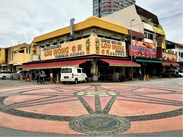 The image shows a bustling street in Singapore with a variety of buildings, stores, name boards,...