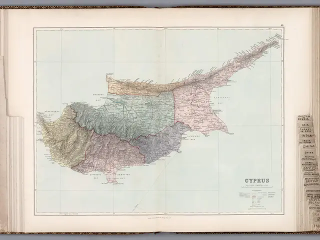 The image shows an open book with a map of Cyprus on it. The map is detailed and shows the various...