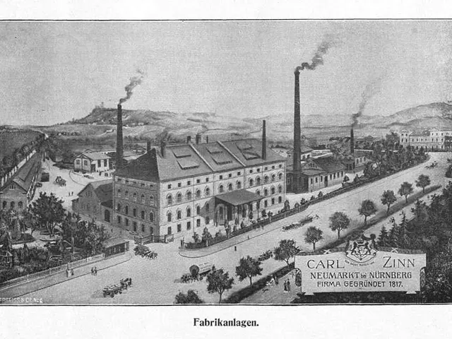 The image shows an old black and white photo of a factory with smoke coming out of its chimneys,...