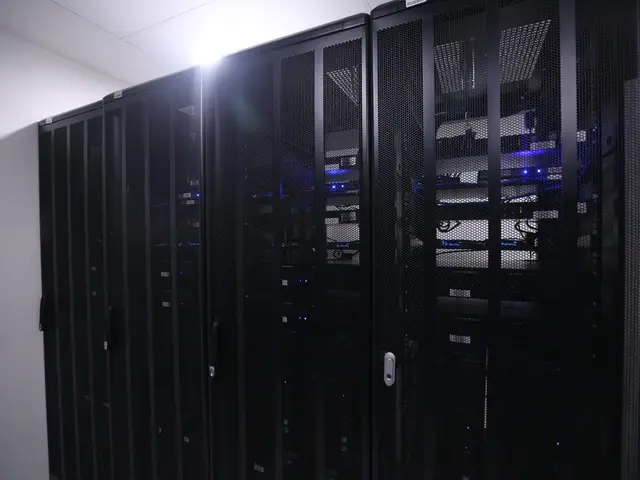The image shows a row of servers in a data center, with a wall in the background and a light at the...