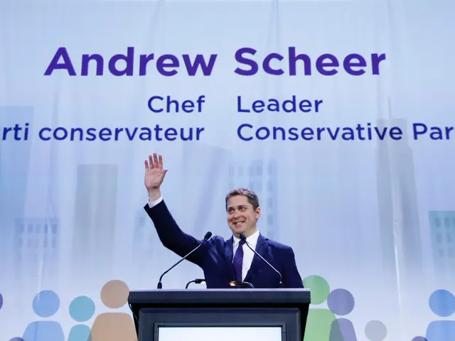 The image shows Andrew Scheer, the Chief Leader of the Conservative Party, standing in front of a...