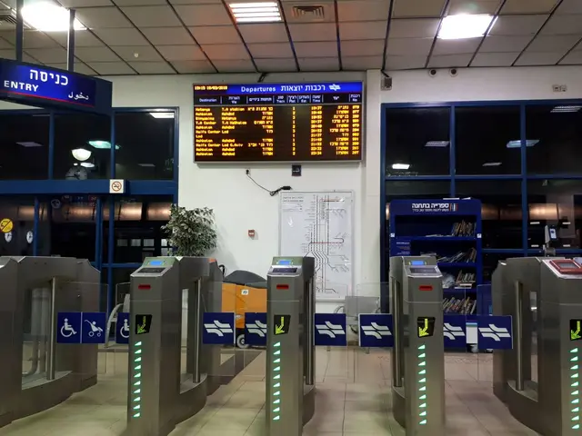 The image shows a man standing in front of a metal turnstile in an airport, surrounded by metal...