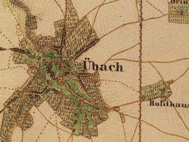 The image shows an old map of the city of Ubach, Germany, with text written on it. The map is...