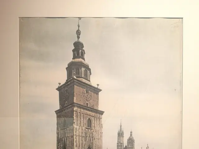 The image shows a black and white photo of a clock tower in Germany, surrounded by buildings and...