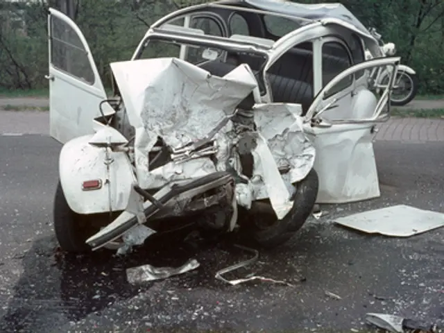 The image shows a car that has been involved in a crash on the side of the road, with its front end...