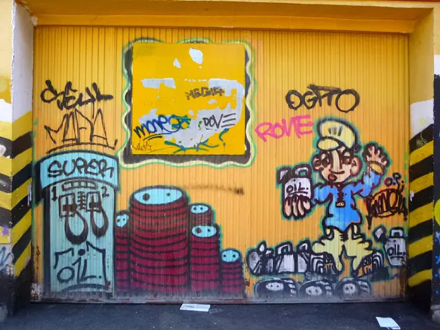 The image shows a yellow garage door with graffiti on it in front of a building. The graffiti is...