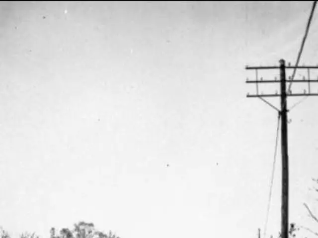 The image shows a group of people walking down a snow-covered street in Rodesund, Germany in 1921....