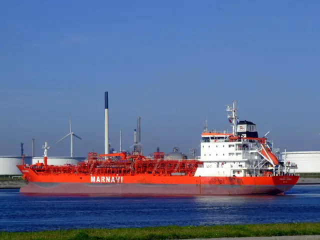 The image shows a large red and white oil tanker floating on top of a body of water, surrounded by...