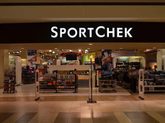 The image shows a sportchek store in a mall with a sign that reads "Sportchek" on the wall. Inside...