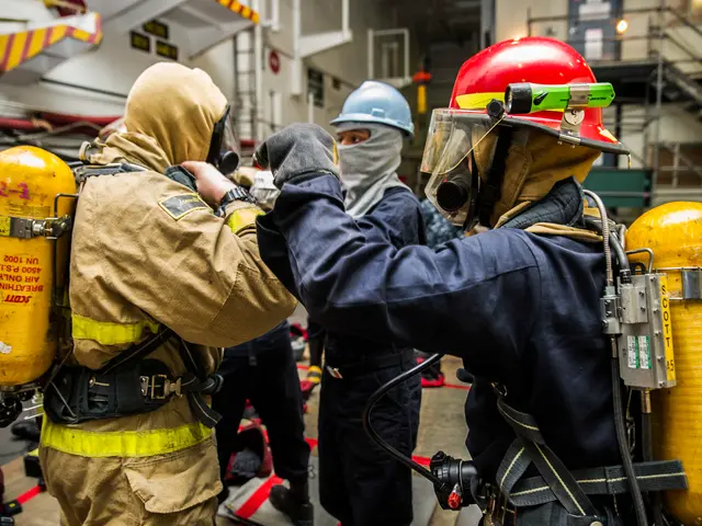 The image shows a group of firefighters in protective gear standing next to each other. They are...