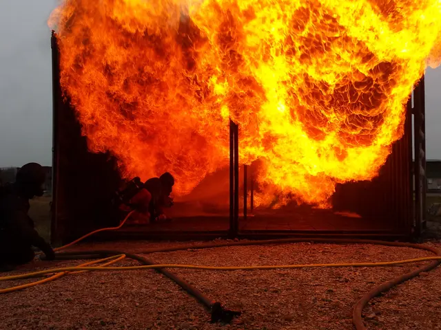 The image shows a group of firefighters working to put out a fire in a building, with a pipe on the...