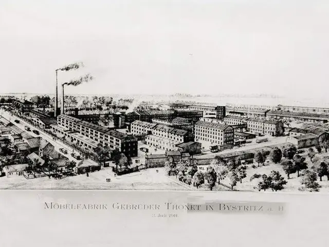 The image shows an old black and white drawing of a city with lots of buildings, trees, vehicles on...