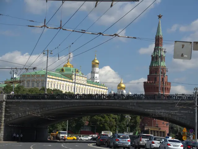 The image shows a bustling street in Moscow, Russia, with vehicles driving on the road, a bridge...