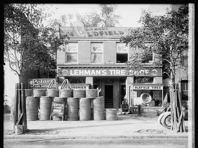 The image shows a black and white photo of Lehman's Tire Shop in Detroit, Michigan. In the center...
