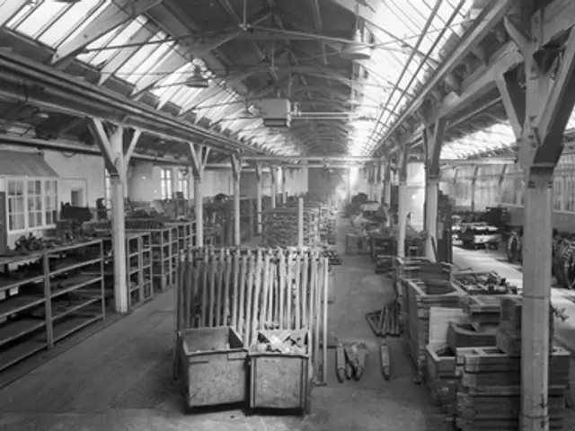 The image shows a black and white photo of a large warehouse filled with lots of tools, including...