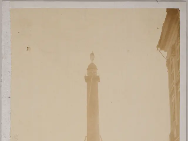 The image shows an old photo of a monument in the middle of a city, surrounded by buildings, street...