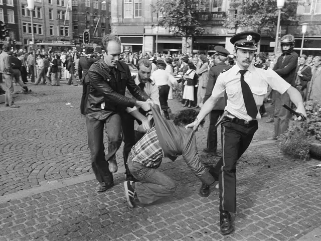 The image shows a black and white scene of a man being dragged by two police officers on the...