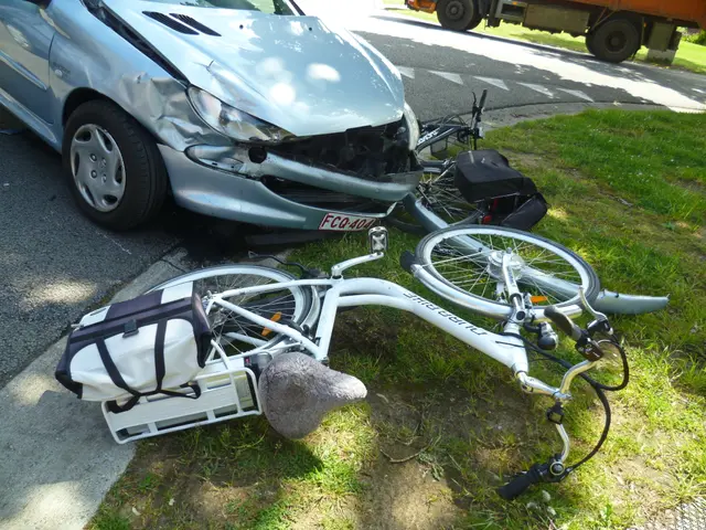 The image shows a car that has been involved in a crash on the side of the road, with a bicycle...