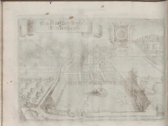The image shows an open book with a drawing of a city on it. The drawing is detailed and shows the...