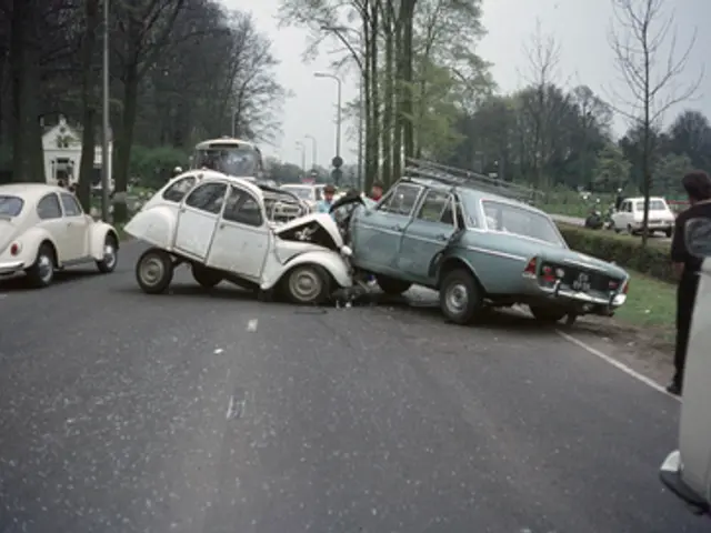 The image shows two cars that have been involved in a car accident on the side of the road. There...