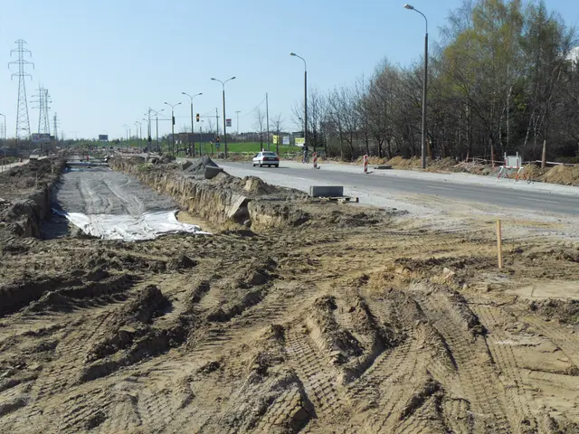 The image shows a construction site with a large pile of dirt on the side of the road. There are...